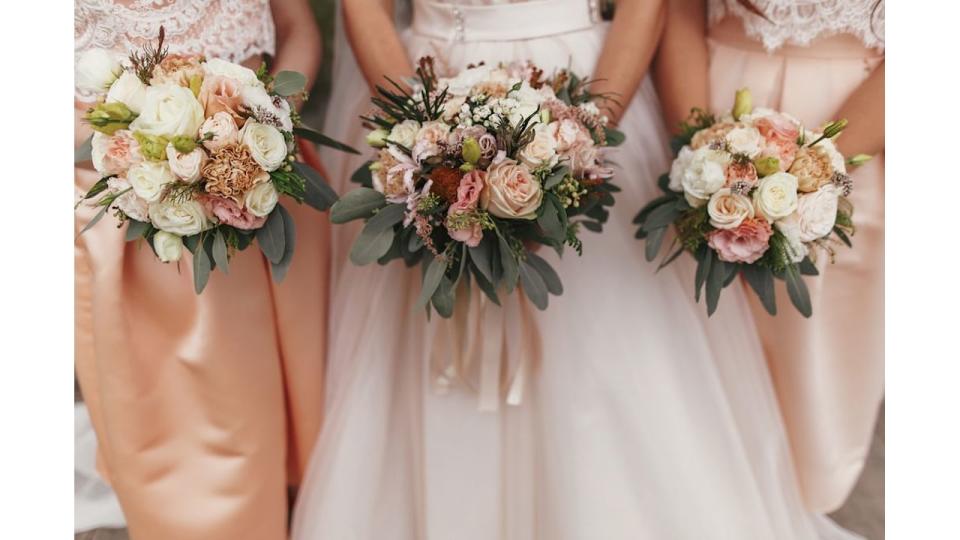 Bridesmaids holding wedding bouquets