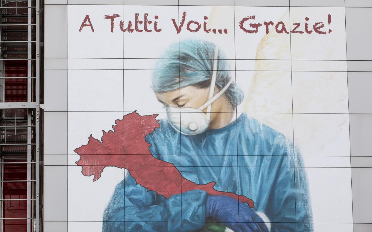 A mural dedicated to all Italian medical workers depicting a nurse cradling Italy and reading 'To All Of You... Thank You!', on a wall of Papa Giovanni XXIII Hospital in Bergamo, near Milan, Italy -  Emanuele Cremaschi / Getty
