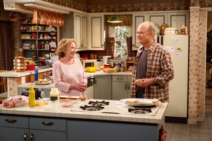 Debra and Kurtwood standing in front of the stove in a scene from That 90's Show