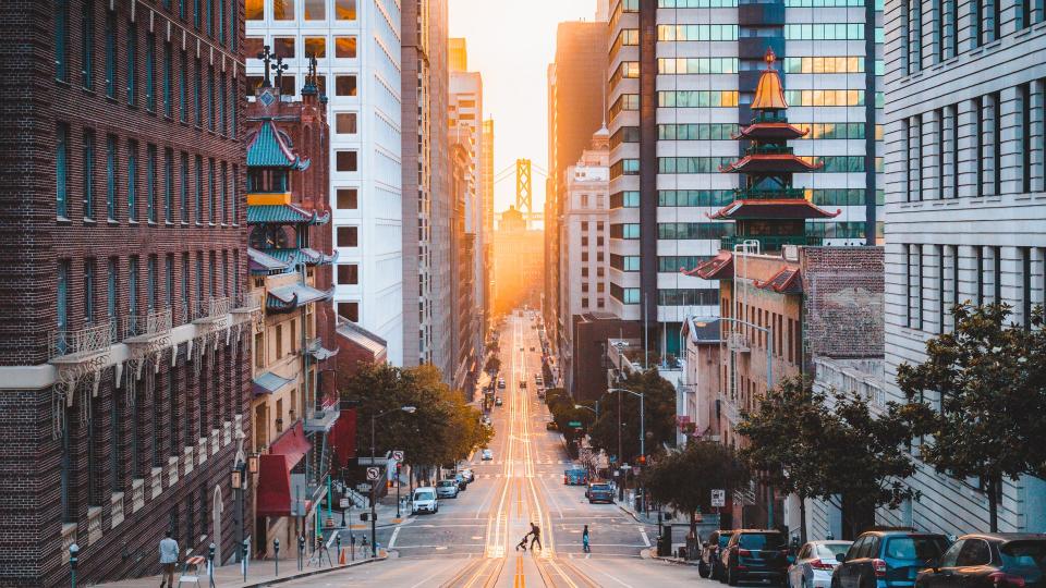 Beautiful view of downtown San Francisco with famous California Street illuminated in first golden morning light at sunrise in summer, San Francisco, California, USA.