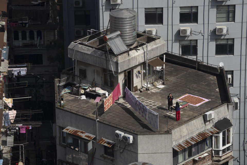 Residents socially distance as they talk on the rooftop of a residential building in Wuhan on Thursday, Oct. 22, 2020. (AP Photo/Ng Han Guan)