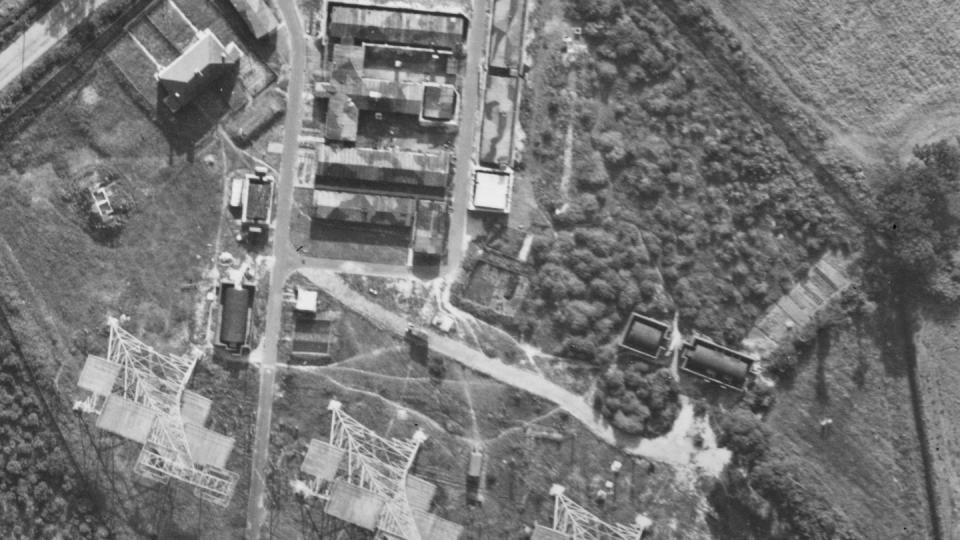 In this aerial photo released by the Historic England Archive taken by the United States Army Air Force, a view of Chain Home radar station in Darsham, England, on Aug. 5, 1944, showing the four transmitter aerial towers and camouflaged huts. (Historic England Archive /USAAF Photography via AP)