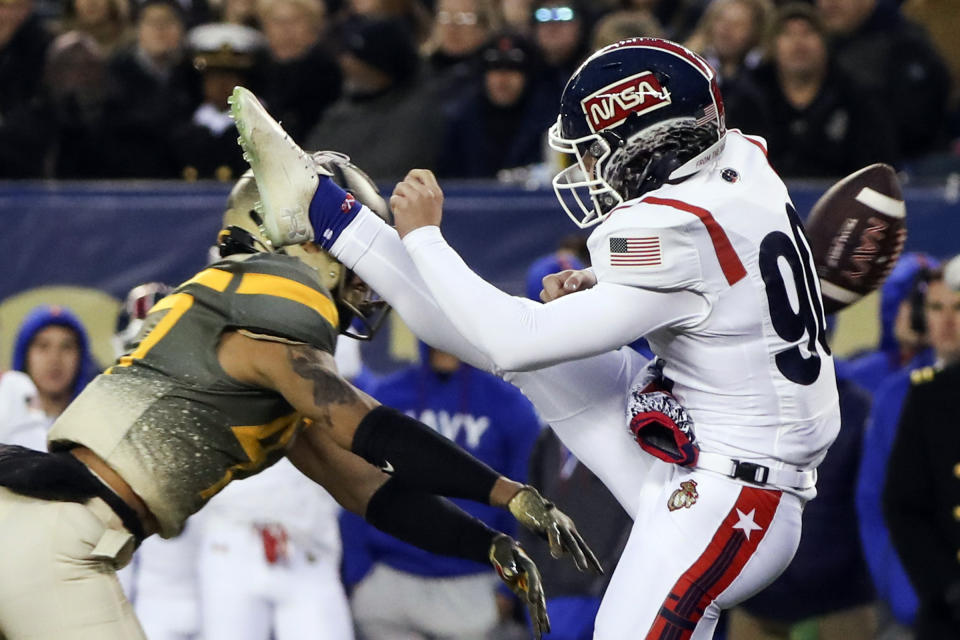 Army defensive back Noah Short (47) blocks a punt return by Navy punter Riley Riethman (90) for a touchdown in the second quarter of an NCAA college football game in Philadelphia, Saturday, Dec. 10, 2022. (Heather Khalifa/The Philadelphia Inquirer via AP)