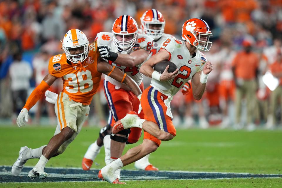 Dec 30, 2022; Miami Gardens, FL, USA; Clemson Tigers quarterback Cade Klubnik (2) runs with the ball ahead of Tennessee Volunteers linebacker Solon Page III (38) during the first half of the 2022 Orange Bowl at Hard Rock Stadium. Mandatory Credit: Jasen Vinlove-USA TODAY Sports