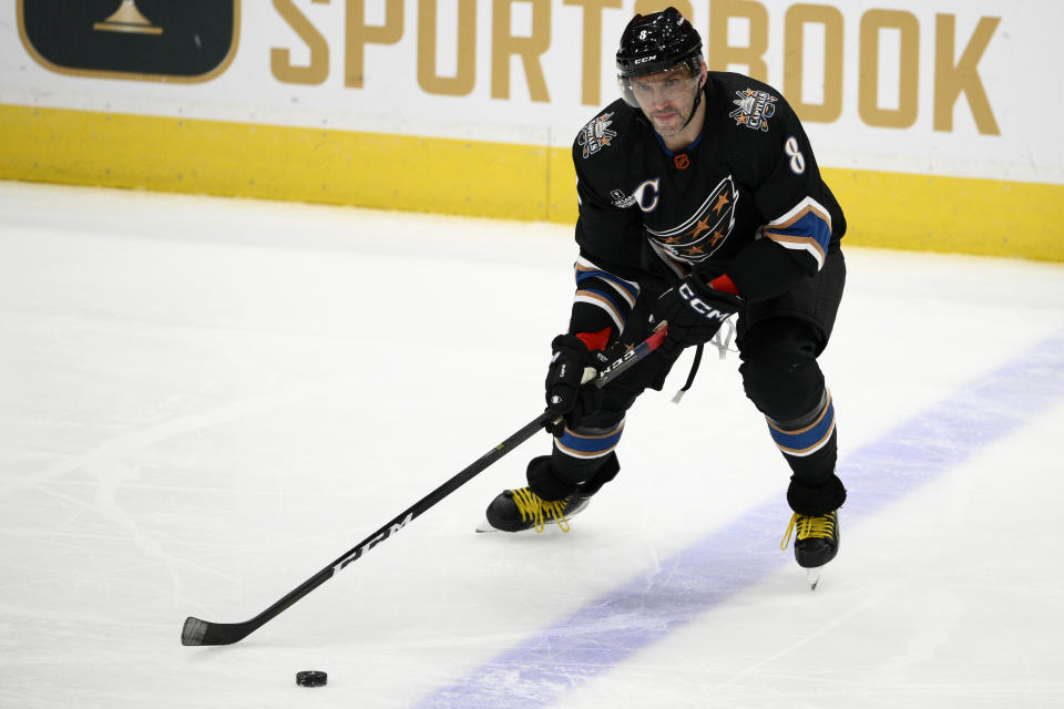 Washington Capitals left wing Alex Ovechkin (8) skates with the puck during the first period of an NHL hockey game against the Winnipeg Jets, Friday, Dec. 23, 2022, in Washington. (AP Photo/Nick Wass)