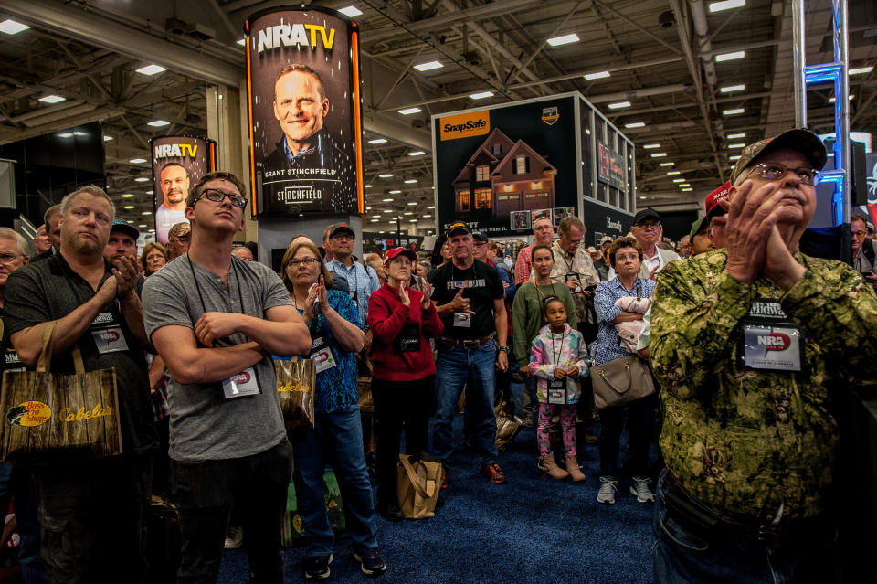 A crowd watches a screen showing a live feed of President Trump's speech at the NRA annual meeting on May 4. (Photo: Joseph Rushmore for HuffPost)