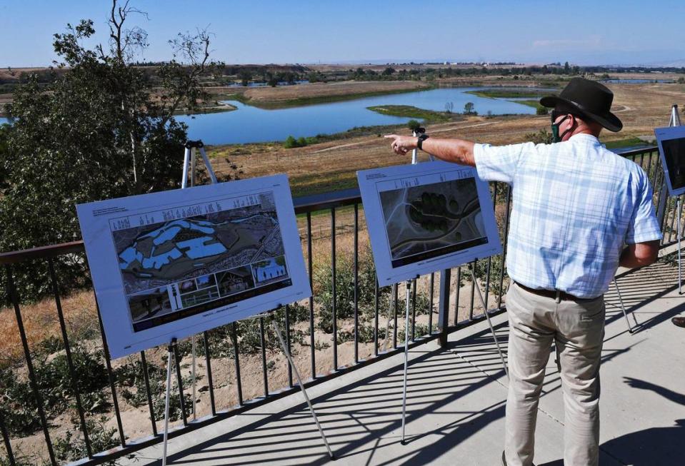 San Joaquin River Conservancy Executive Officer John Shelton points out over the San Joaquin River bason as plans are announced to help increase public access to the river at a press conference May 5, 2021 in Fresno. The City of Fresno is committing $1 million for a traffic light at Audubon and Del Mar Avenues.