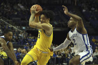 Michigan Wolverines' Jaelin Llewellyn (3) drives past Kentucky Wildcats' Sahvir Wheeler (2) during an NCAA basketball game between Michigan Wolverines and Kentucky Wildcats at the O2 Arena, in London, Sunday, Dec.4, 2022. (AP Photo/Ian Walton)