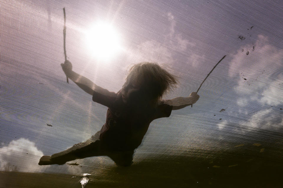  A child plays a trampoline in the front yard of his home in New Freeport, Pa., on March 29, 2023. (Justin Merriman for NBC News)