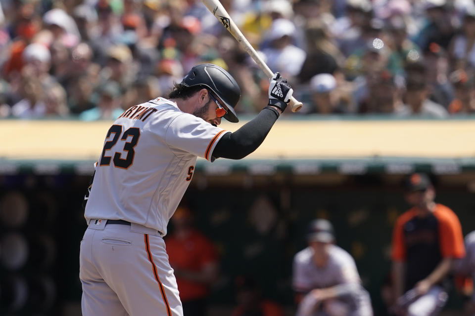 San Francisco Giants' Kris Bryant reacts after striking out against the Oakland Athletics during the fourth inning of a baseball game in Oakland, Calif., Sunday, Aug. 22, 2021. (AP Photo/Jeff Chiu)