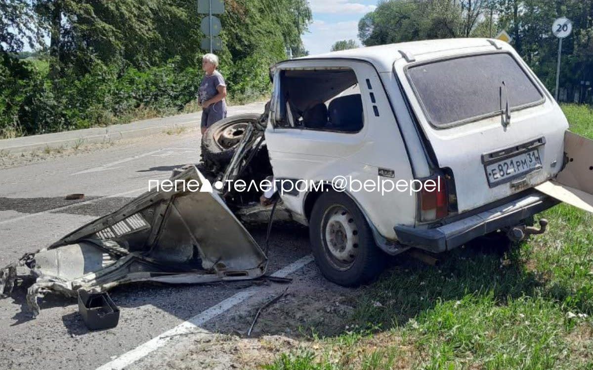 A person stands outside the wreckage of the car after the incident that killed the driver