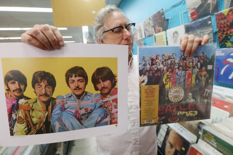 Customer service represenative Joe Steinman reads the back of the Beatles' "Sgt. Peppers" album and a poster being given away at Vintage Vinyl Records in University City, Mo., on the 50th anniversary of the release of the album in the United States, on June 2. On August 14, 1985, Michael Jackson paid $47 million at auction for the rights to 40,000 songs, including most of the Beatles classics. Photo by Bill Greenblatt/UPI