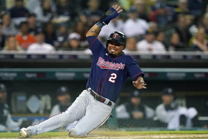 Minnesota Twins' Luis Arraez safely slides into home plate from third on a single by teammate Gio Urshela during the fifth inning of a baseball game against the Detroit Tigers, Saturday, Oct. 1, 2022, in Detroit. (AP Photo/Carlos Osorio)