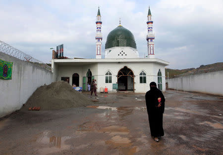 A woman leaves after visiting a shrine where the grave of Mumtaz Qadri is situated, the man Pakistan executed last year for assassinating a governor who proposed reforming the country’s blasphemy laws, on the outskirts of Islamabad, Pakistan, January 5, 2017. Picture taken January 5, 2017. REUTERS/Faisal Mahmood