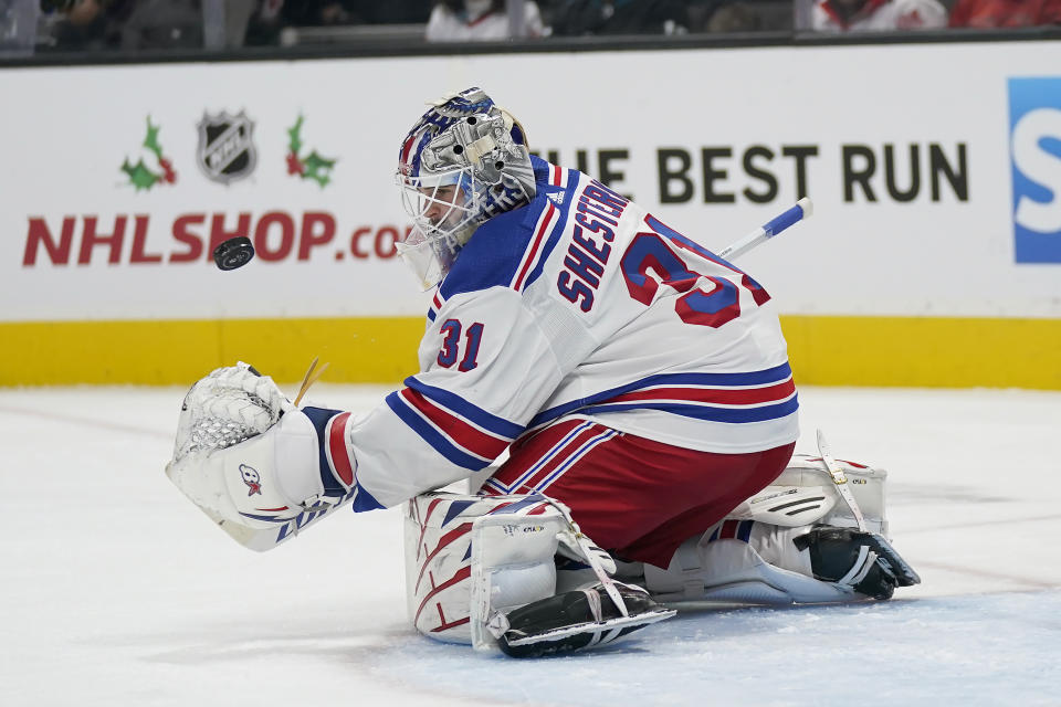 New York Rangers goaltender Igor Shesterkin reaches for the puck after defending against a San Jose Sharks shot during the first period of an NHL hockey game in San Jose, Calif., Saturday, Nov. 19, 2022. (AP Photo/Jeff Chiu)