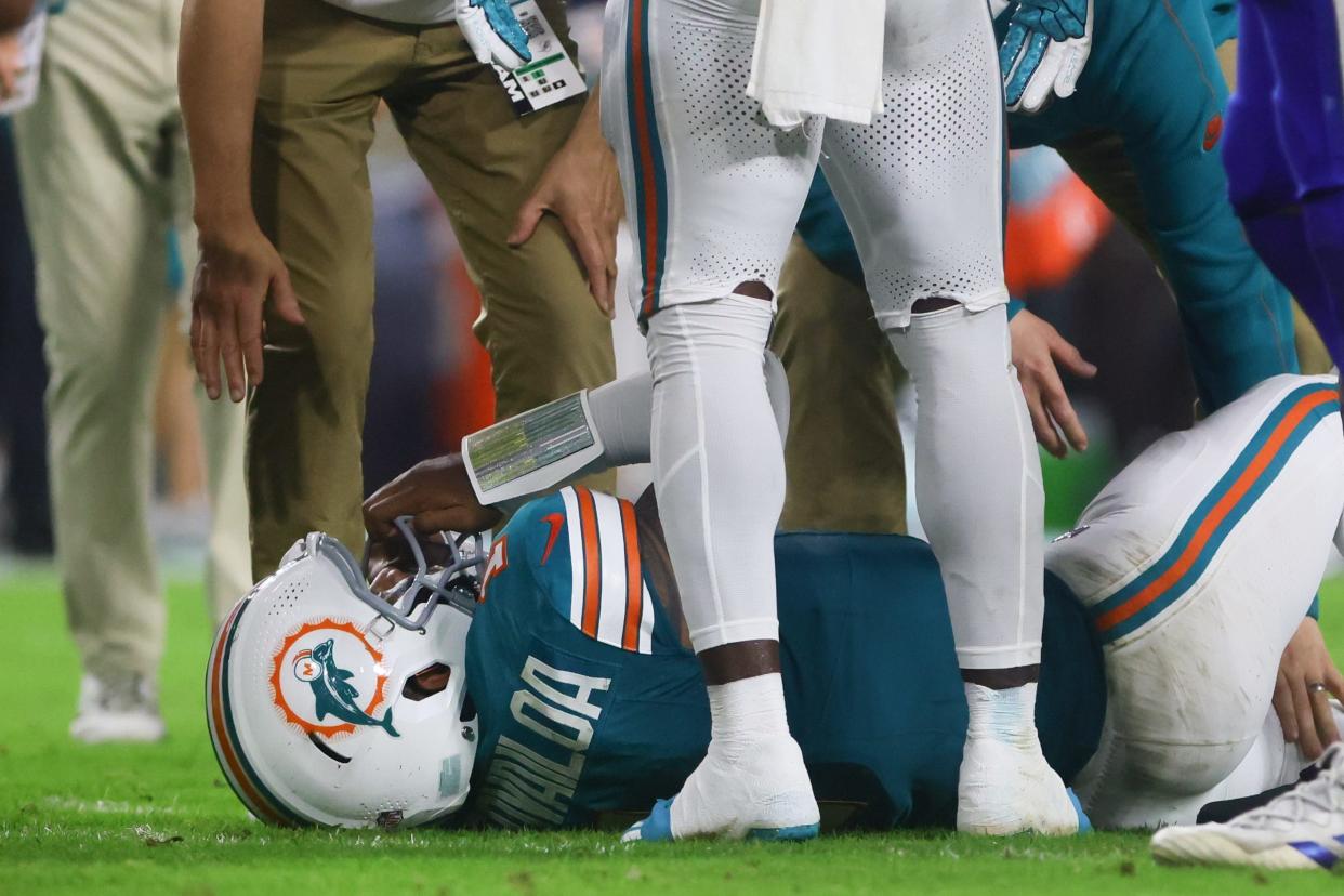 Sep 12, 2024; Miami Gardens, Florida, USA; Miami Dolphins quarterback Tua Tagovailoa (1) is checked on by trainers after an apparent injury against the Buffalo Bills during the third quarter at Hard Rock Stadium. Mandatory Credit: Sam Navarro-Imagn Images