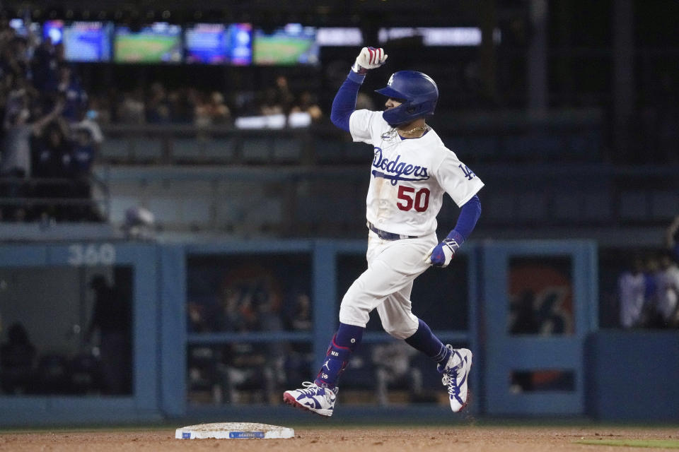 Los Angeles Dodgers' Mookie Betts celebrates as he rounds second after hitting a three-run home run during the fifth inning of a baseball game against the Atlanta Braves Thursday, Aug. 31, 2023, in Los Angeles. (AP Photo/Mark J. Terrill)