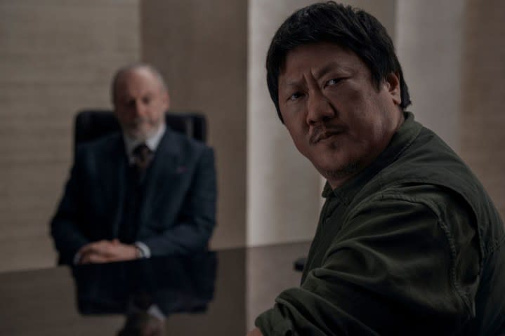 Liam Cunningham sits behind Benedict Wong in 3 Body Problem.