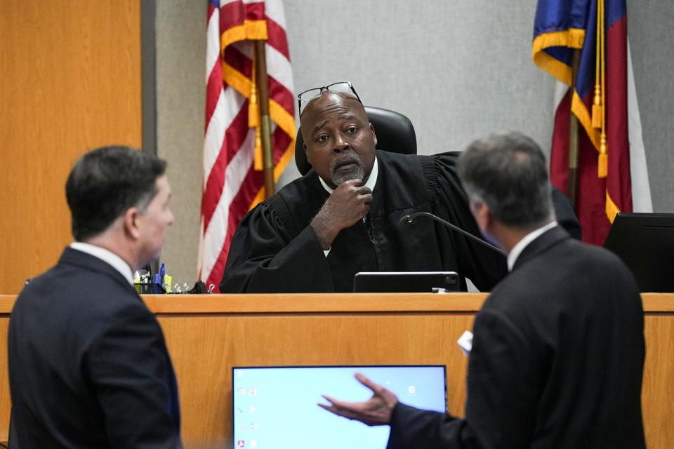 District Judge Clifford Brown speaks with defense attorney Clint Broden, left, and prosecutor Guillermo Gonzales during Daniel Perry's murder trial.