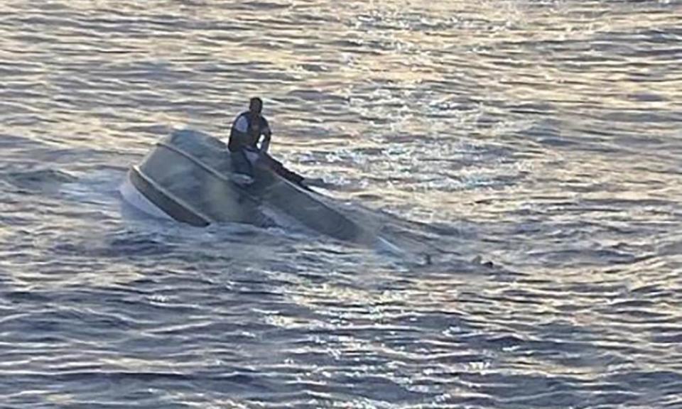 An image provided by the Coast Guard shows a capsized vessel approximately 45 miles east of Fort Pierce inlet, Florida