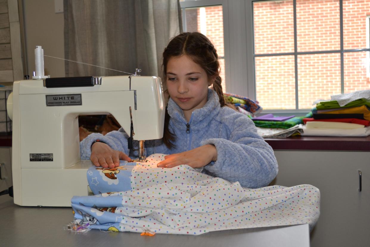 Luciana Rithcie, a Lake Center Christian School fifth-grader, learns to use a sewing machine, completing her own pillowcase as part of future ready skill building at the school.