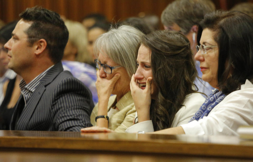 Sister of Oscar Pistorius, Aimee Pistorius, second from right, cries as she listens as her brother testifies in court in Pretoria, South Africa, Tuesday, April 8, 2014. Pistorius is charged with the murder of his girlfriend Reeva Steenkamp, on Valentines Day 2013. (AP Photo/Kim Ludbrook, Pool)