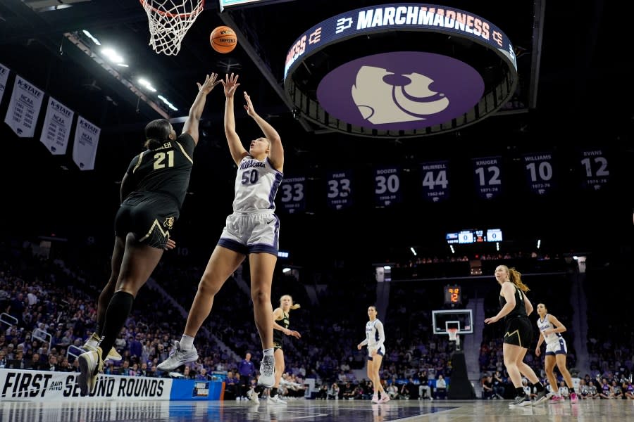 Kansas State center Ayoka Lee (50) shoots over Colorado center Aaronette Vonleh (21) during the first half of a second-round college basketball game in the women’s NCAA Tournament in Manhattan, Kan., Sunday, March 24, 2024, in Manhattan, Kan. (AP Photo/Charlie Riedel)