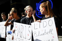 Lido cabaret employees react during a demonstration to try to save their jobs and the history of the cabaret, known for its dinner theater and its "Bluebell Girls" revue, Saturday, May 28, 2022 in Paris. Amid financial troubles and changing times, the venue's new corporate owner is ditching most of the Lido's staff and its high-kicking, high-glamour dance shows — which date back decades and inspired copycats from Las Vegas to Beirut — in favor of more modest musical revues. (AP Photo/Thomas Padilla)