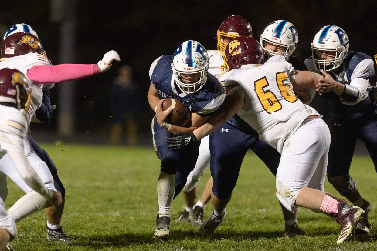 Rootstown senior running back Cody Coontz runs through a gap in the defensive line during Friday night's game against the Southeast Pirates in Rootstown.