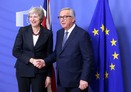 British Prime Minister Theresa May shakes hands with European Commission President Jean-Claude Juncker before a meeting to discuss draft agreements on Brexit, at the EC headquarters in Brussels, Belgium November 21, 2018. REUTERS/Francois Walschaerts