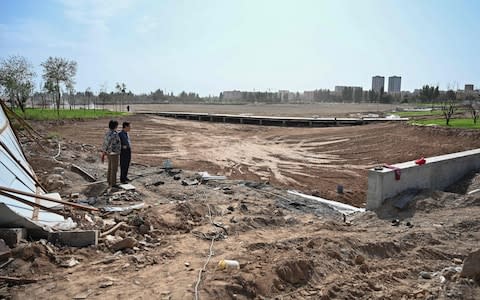 This photo taken on September 13, 2019 shows the works of a park in a place where before there was a Uighur cemetery in Kuche in the region of Xinjiang. - Credit: AFP