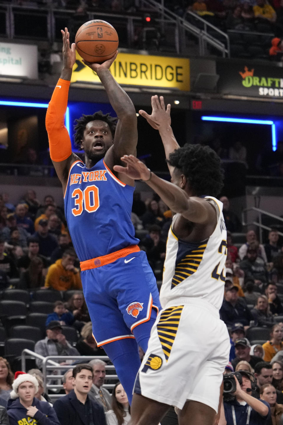 New York Knicks forward Julius Randle (30) shoots over Indiana Pacers forward Aaron Nesmith during the first half of an NBA basketball game in Indianapolis, Sunday, Dec. 18, 2022. (AP Photo/AJ Mast)