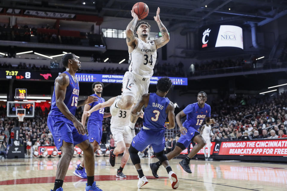 Cincinnati's Jarron Cumberland (34) shoots over SMU's Kendric Davis (3) during the first half of an NCAA college basketball game Tuesday, Jan. 28, 2020, in Cincinnati. (AP Photo/John Minchillo)