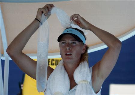 Maria Sharapova of Russia holds ice on her head during her women's singles match against Karin Knapp of Italy at the Australian Open 2014 tennis tournament in Melbourne January 16, 2014. REUTERS/David Gray