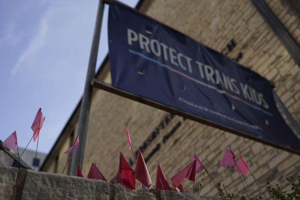 A sign encouraging the protection of transgender children stands at Central Presbyterian Church near the Texas Capitol, Tuesday, Aug. 15, 2023, in Austin, Texas. Waiting lists for gender-affirming health care are growing in states that declared themselves refuges for transgender people as bans for such care for minors take effect around the country. Texas, one of the largest states, has a ban that's set to take effect Sept. 1. (AP Photo/Eric Gay)