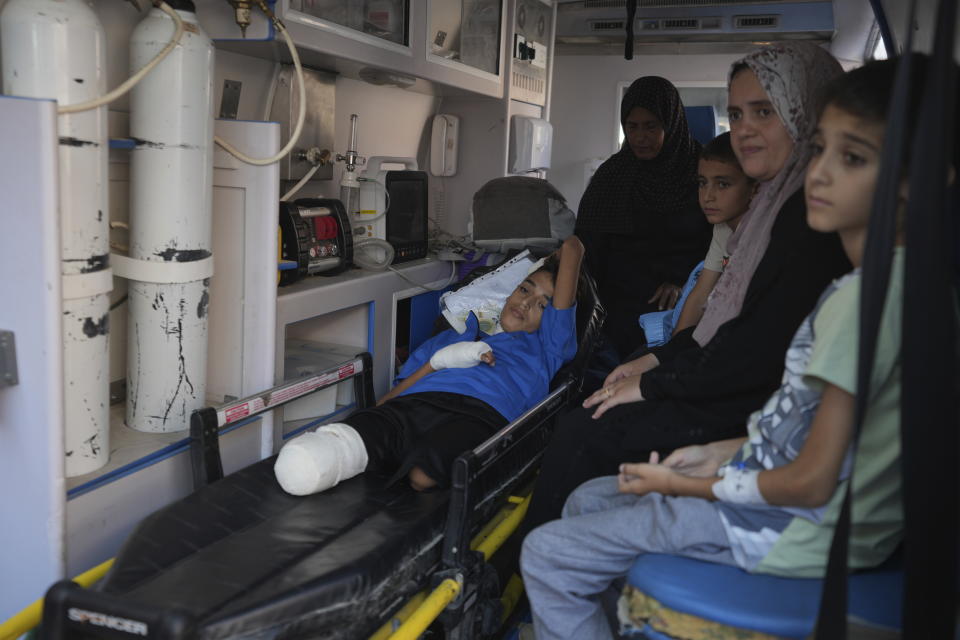 An amputee Palestinian child sits in an ambulance with his relatives as he waits to leave the Gaza Strip for treatment abroad through the Kerem Shalom crossing, in Khan Younis, southern Gaza Strip, Thursday, June 27, 2024. 21 patients in the Gaza Strip evacuated the war-torn enclave in an initiative led by the World Health Organization for the children to receive life-saving treatment elsewhere. (AP Photo/Abdel Kareem Hana)