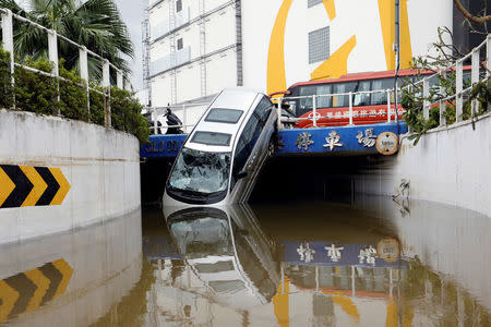 A vehicle damaged by Typhoon Hato is seen in Macau. REUTERS/Tyrone Siu