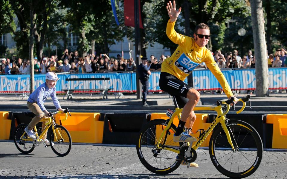 Wiggins rides with his son Ben on the Champs-Elysees after winning the Tour - AP