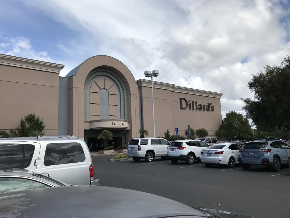 The parking lot and exterior of a Dillard's store.