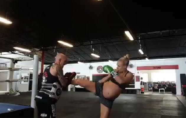 Champion fighter Caley isn't letting her bump stop her from training. Photo: Facebook/CaleyReece