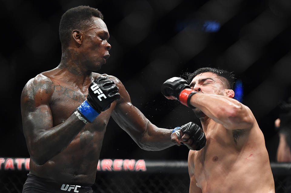 ATLANTA, GEORGIA - APRIL 13: Israel Adesanya of Nigeria punches Kelvin Gastelum during the UFC 236 event at State Farm Arena on April 13, 2019 in Atlanta, Georgia. (Photo by Logan Riely/Getty Images)