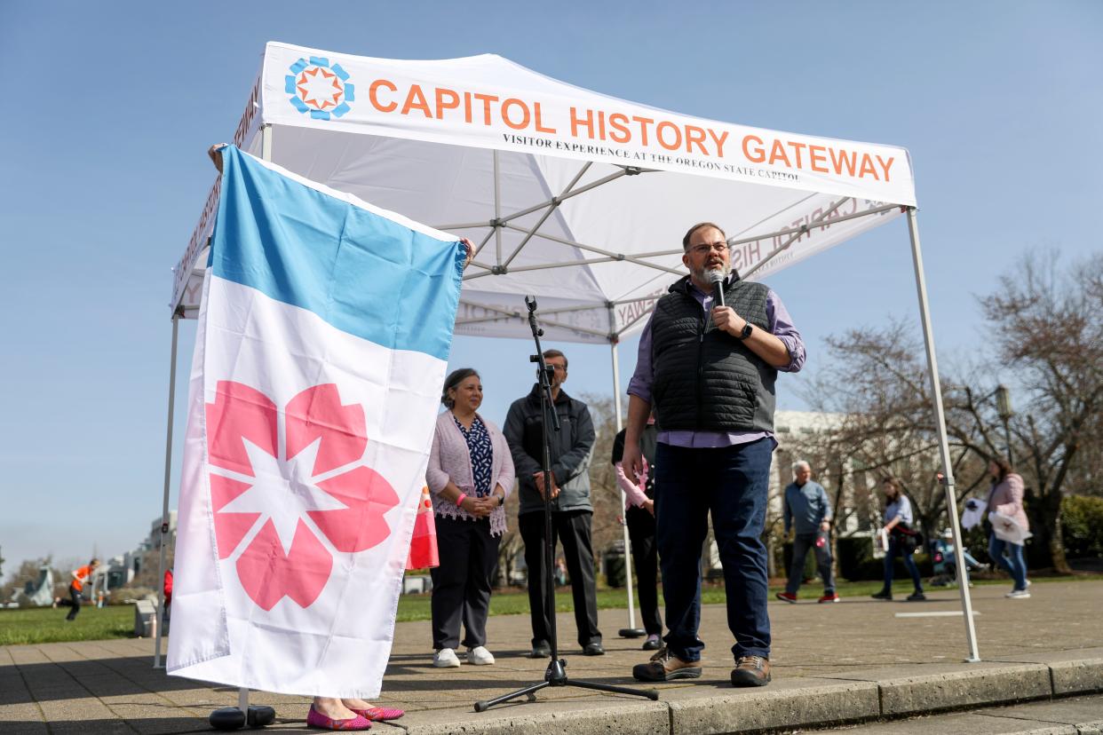 Mayor Chris Hoy introduces a new Salem flag with imagery representing cherry blossoms during Cherry Blossom Day in March 2023 at the Oregon State Capitol.