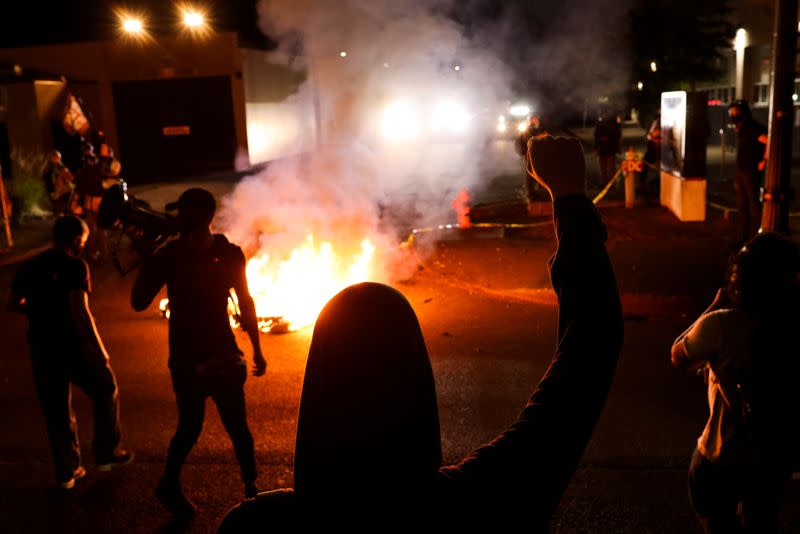 Protesters gather outside the Portland Police Bureau's North Precinct on the 101th consecutive night of protests against police violence and racial inequality, in Portland