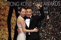 Chinese actor Zhang Jin poses with his wife actress Ada Choi backstage after he won Best Supporting Actor for his role in the movie "The Grandmaster" at the 33rd Hong Kong Film Awards in Hong Kong April 13, 2014. REUTERS/Bobby Yip (CHINA - Tags: ENTERTAINMENT)