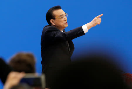 Chinese Premier Li Keqiang gestures as he leaves at the end of a news conference following the closing session of the National People's Congress (NPC) at the Great Hall of the People in Beijing, China March 15, 2019. REUTERS/Thomas Peter