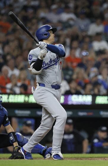 Los Angeles Dodgers' Shohei Ohtani hits a double that bounced over the center field.