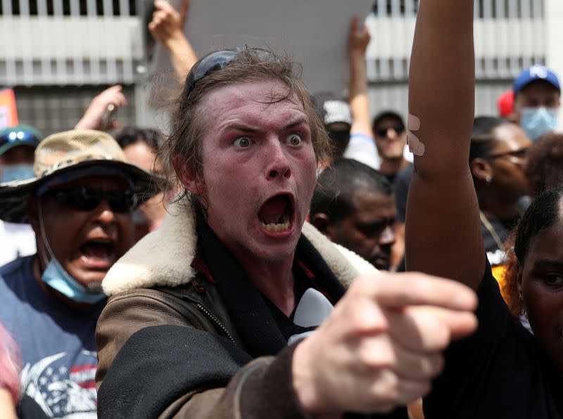 A protester shouts at U.S. President Donald Trump supporters outside the venue of U.S. President Donald Trump's rally in Tulsa