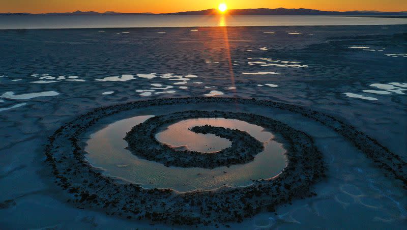The sun sets on the Spiral Jetty on the Great Salt Lake on Thursday, March 16, 2023.