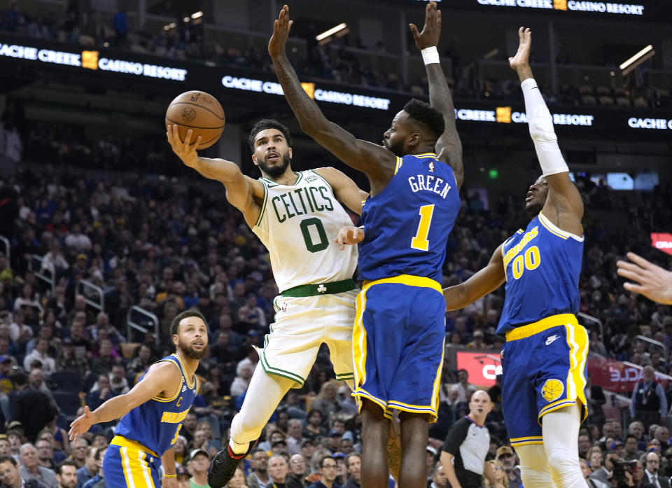 Jayson Tatum #0 of the Boston Celtics shoots over JaMychal Green #1 of the <a class="link " href="https://sports.yahoo.com/nba/teams/golden-state/" data-i13n="sec:content-canvas;subsec:anchor_text;elm:context_link" data-ylk="slk:Golden State Warriors;sec:content-canvas;subsec:anchor_text;elm:context_link;itc:0">Golden State Warriors</a> during the first quarter of an NBA basketball game at Chase Center on December 10, 2022, in San Francisco, California. (Thearon W. Henderson/Getty Images)