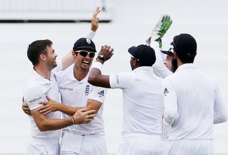 Cricket - West Indies v England - Second Test - National Cricket Ground, Grenada - 21/4/15 England's James Anderson celebrates the wicket of West Indies' Kraigg Brathwaite with team mates Action Images via Reuters / Jason O'Brien